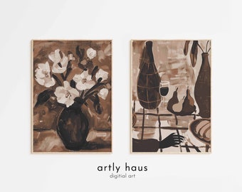 May include: Two rectangular wall art prints in a monochromatic brown palette. The left print depicts white flowers in a dark vase. The right print shows a still life with two bottles, a glass, and pears on a checkered surface. Text reads artly haus.
