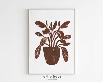 May include: A framed wall art print featuring a dark reddish-brown block print illustration of a potted plant with textured leaves and stems. The artwork is centered on a white background, and the text "artly haus digital art" appears below.