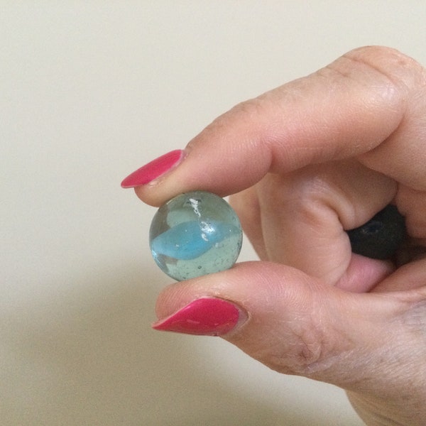 Two marbles found on a beach. Beautiful blue colours. Cats eyes.