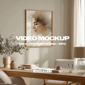 May include: A framed watercolor portrait of a woman in profile hangs on a beige wall. The image is part of a video mockup, with text that reads "VIDEO MOCKUP" and "DIN A - PHOTOSHOP (PSD + MP4)". A wooden desk with books, a lamp, and a vase is in the foreground.