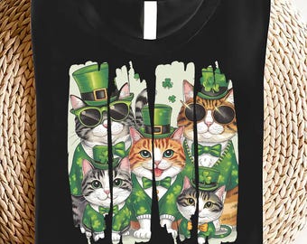 May include: Black t-shirt with a graphic of five cats dressed in green shamrock hats and green clothing. The text "Happy St. Pawtrick's Day" is printed below the cats.