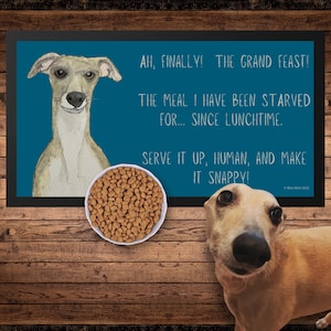 May include: A blue and white doormat with a cartoon greyhound dog and the text "AH, FINALLY! THE GRAND FEAST! THE MEAL I HAVE BEEN STARVED FOR... SINCE LUNCHTIME. SERVE IT UP, HUMAN, AND MAKE IT SNAPPY!"