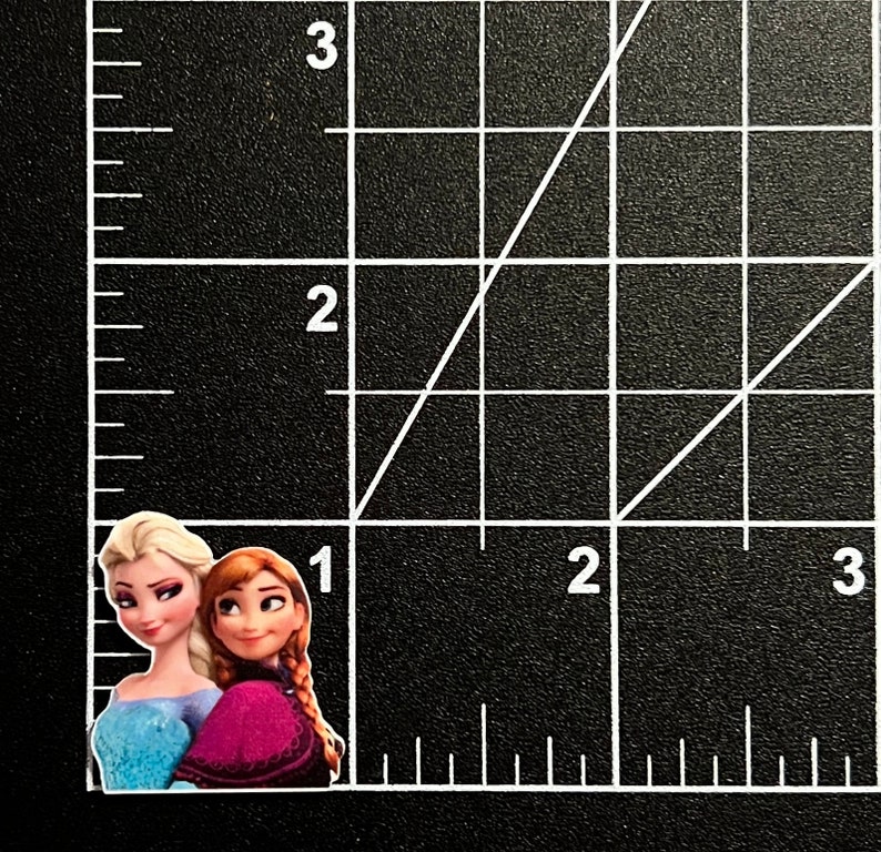 Puede incluir: Dos personajes de dibujos animados, uno con el pelo largo y rubio que lleva un vestido azul claro y el otro con el pelo largo y rojo que lleva un vestido morado, est&aacute;n de pie uno al lado del otro.