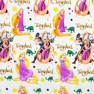 Puede incluir: Patrón repetido con personajes de la película animada "Enredados". El diseño incluye a la princesa con largo cabello rubio en un vestido morado, un camaleón verde y la palabra "Tangled" en dorado.