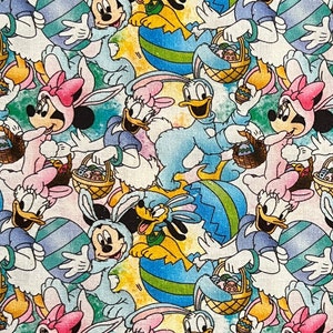 May include: A colorful fabric featuring a repeating pattern of Disney characters dressed in Easter bunny costumes. Mickey Mouse, Minnie Mouse, Donald Duck, Daisy Duck, and Pluto are holding baskets of Easter eggs. The background is a light yellow with blue and green swirls.
