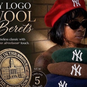 May include: A collection of wool berets featuring the white NY logo. The berets are available in red, green, brown, and navy blue. A bronze-colored circular emblem displays a building with the text MADE IN THE BRONX and THE BOOGIE DOWN.