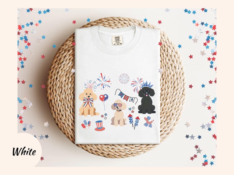May include: White t-shirt with a festive Fourth of July design featuring three dogs wearing party hats and surrounded by fireworks, stars, and the word "USA".