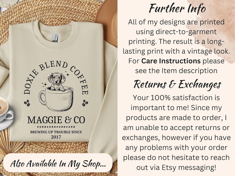May include: Cream-colored sweatshirt featuring a dachshund dog in a coffee cup, with the text "Doxie Blend Coffee" and "Maggie & Co Brewing Up Trouble Since 2017." The design is printed on the front.