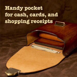 May include: Open leather wallet with the text "Handy pocket for cash, cards, and shopping receipts." The wallet is brown with a lighter tan interior. Inside are cash and a dark brown object.