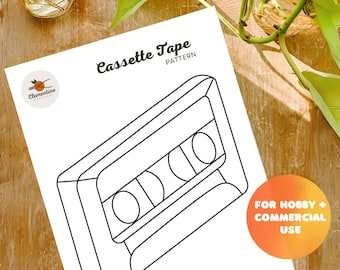 May include: A black and white line drawing of a cassette tape. The drawing is on a white background with the text "Cassette Tape Pattern" above the image. The text "For Hobby + Commercial Use" is in a circle in the lower right corner of the image.