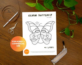 May include: A black and white printable pattern for a stained glass butterfly. The pattern is labeled "GEMINI BUTTERFLY PATTERN" and includes 40 pieces. The text "FOR HOBBY + COMMERCIAL USE" is in a yellow circle.
