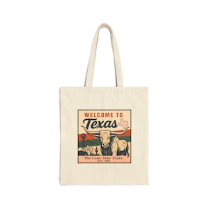 May include: Cream-colored tote bag featuring a graphic that says "Welcome to Texas" with a longhorn steer illustration. The design includes a map of Texas, cacti, and a windmill. The text "The Lone Star State EST. 1845" is also included.