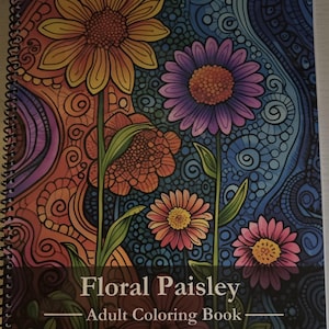 Puede incluir: Un libro para colorear para adultos con un dise&ntilde;o floral paisley. La portada presenta una variedad de flores en tonos de amarillo, naranja, rojo, morado, rosa y azul. El t&iacute;tulo "Floral Paisley Adult Coloring Book" est&aacute; impreso en marr&oacute;n sobre un fondo negro.