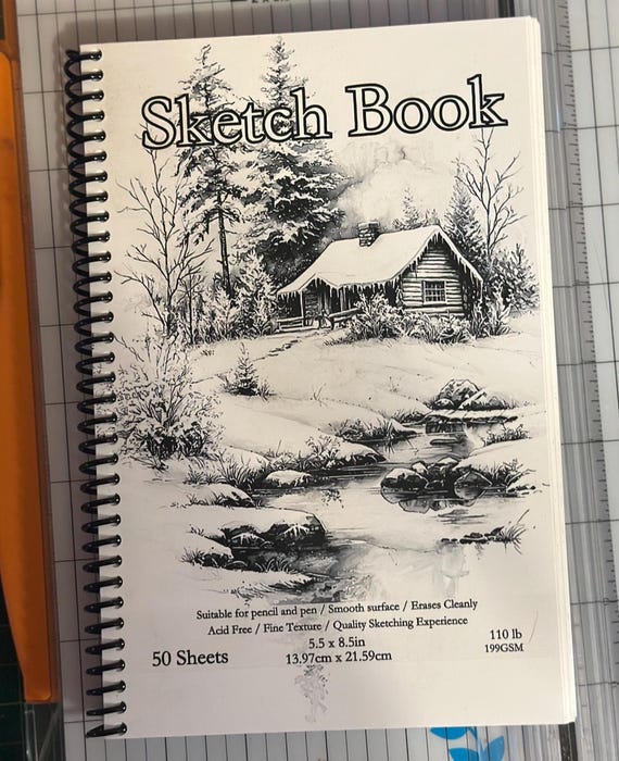 Snowy Christmas Cabin Sketchbook – 5.5″ × 8.5″, 50 Sheets, Spiral Bound, Winter Cabin Artwork, Artist & Travel Drawing Pad