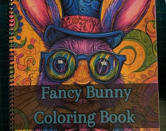 Könnte beinhalten: Ein farbenfrohes Malbuch mit einem Cartoon-Hasen, der einen Zylinder, eine Brille und eine Fliege trägt. Der Titel auf dem Cover lautet "Fancy Bunny Coloring Book".