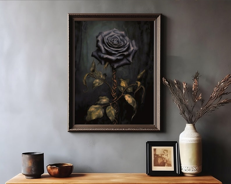 May include: A framed print of a dark blue rose with a gold stem and leaves against a dark green background.