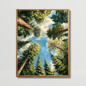 May include: A framed painting depicts a view looking up through tall trees towards a blue sky with fluffy white clouds. The artwork features a gold-colored frame and a vibrant color palette of greens, blues, and browns, creating a sense of depth and perspective.