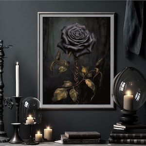 May include: A framed print of a dark, almost black rose with a twisted stem and green leaves against a dark background. The print is displayed on a dark wall with candles and other decor.