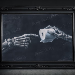 May include: Black framed art print featuring a skeletal hand reaching for a roll of toilet paper held by another skeletal hand. The artwork is set against a dark background, creating a striking contrast.