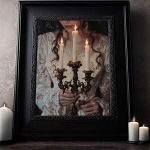 May include: A woman in a white dress holds a candelabra with four lit candles. The candles are white and the candelabra is ornate and dark brown. The woman's hands are visible, and she is looking down at the candles.