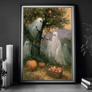 May include: A framed print featuring a whimsical Halloween scene. White ghosts with black eyes are gathered around a tree with orange fruit. A pumpkin and a basket of apples sit at the base of the tree. The words "Rave In Prints" are printed on the image.