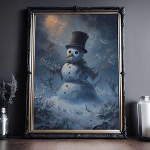 May include: Framed artwork featuring a spooky snowman with a top hat, scarf, and skeletal arms. The winter scene has a dark, cloudy sky and a snowy landscape. The artwork is in a black frame.