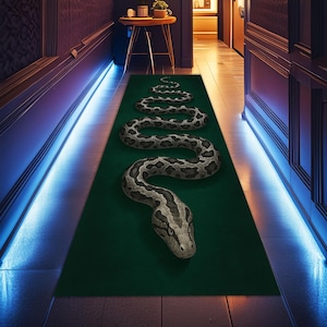 May include: A green rectangular rug with a large snake design. The snake is gray and black with a detailed pattern, winding across the rug. The rug is placed in a hallway with blue lighting.