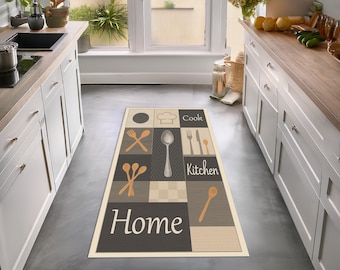 May include: Rectangular kitchen rug with a cream border and a pattern of squares in gray, beige, and cream. The rug features images of kitchen utensils and the words "Cook," "Kitchen," and "Home."
