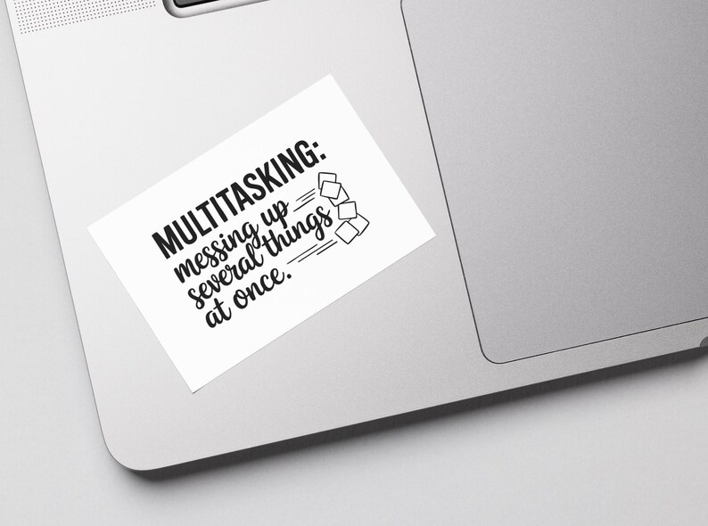 May include: White sticker with black text that reads "MULTITASKING: messing up several things at once."  A simple black line drawing of several squares stacked on top of each other is to the right of the text.
