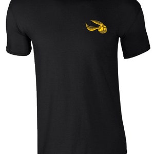 May include: Black t-shirt with a yellow embroidered image of a golden snitch from the Harry Potter series.