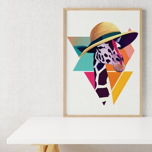 May include: A framed art print of a giraffe wearing a straw hat. The giraffe's head and neck are illustrated with a geometric design, set against a backdrop of colourful triangles in teal, pink, and yellow. The artwork is displayed on a white surface.