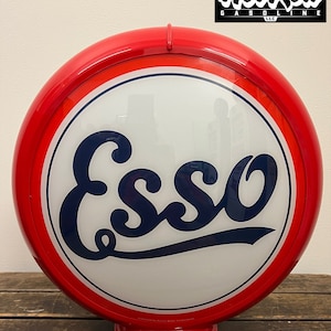 May include: A white ceramic mug with a black handle and the text "But First, Coffee" in a black, handwritten-style font. The mug is on a white surface.