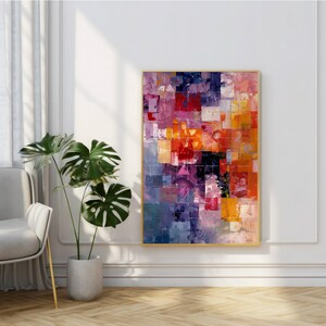 Può includere: Dipinto astratto con un motivo geometrico colorato in tonalità di rosso, arancione, giallo, viola e blu. Il dipinto è incorniciato in oro e appeso a una parete bianca.