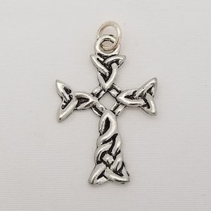 May include: A silver Celtic knot cross pendant with a loop for hanging.