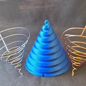 May include: A blue, cone-shaped object is flanked by two wire sculptures. The wire sculptures have a spiral design with a vertical rod. One is silver, and the other is copper-colored. The blue cone has a spiral design.