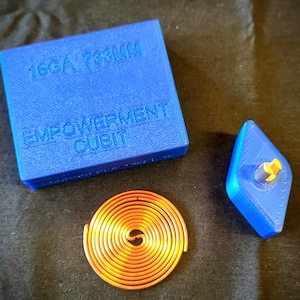 May include: A blue square with the text "16GA 733MM" and "EMPOWERMENT CUBIT" next to a copper coil and a blue diamond-shaped object with a yellow and gray component.