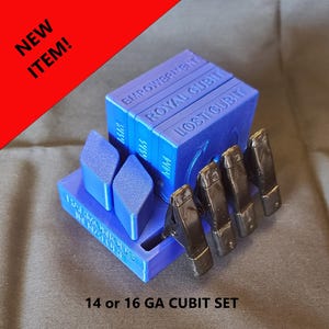 May include: A blue 3D-printed base with the text HARMONIOUS IN NATURE, holding three blue rectangular blocks labeled EMPOWERMENT, ROYAL CUBIT, and LOST CUBIT. Two blue diamond-shaped pieces and four black metal clips are attached to the base.