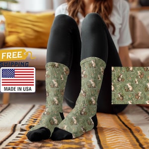 May include: A pair of green socks with a pattern of mice holding flowers and baskets. The socks are made in the USA and feature free shipping.