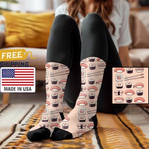 May include: A pair of pink socks with a sushi pattern. The socks feature a variety of sushi rolls, including salmon, tuna, and cucumber. The socks are made of a soft, comfortable material and are perfect for everyday wear.