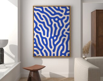 May include: A blue and white abstract print in a wooden frame hangs on a white wall above a wooden stool. The wall is white and the floor is a light wood.