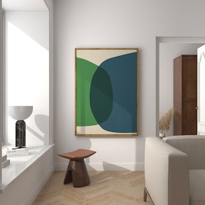 May include: A framed abstract art print with a green, blue, and cream color scheme. The print features overlapping circles and curves.