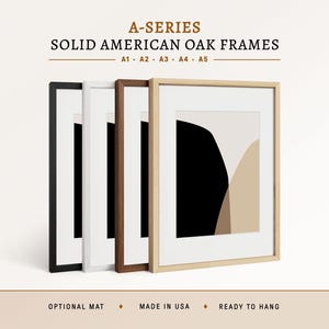 May include: Four solid American oak frames in black, white, dark brown, and natural wood finishes. Each frame contains a white mat and an abstract print with black and beige shapes. Text reads A-SERIES SOLID AMERICAN OAK FRAMES A1 A2 A3 A4 A5.
