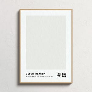 May include: A framed print titled "Cloud Dancer" with a light cream-colored background. The print includes the text "Cloud Dancer" in a modern font, along with color specifications and a black and white houndstooth pattern.