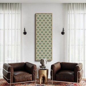 May include: An interior design scene featuring two brown leather armchairs with metal frames, a patterned rug, and a framed artwork with a repeating green and tan design. A wooden side table with a sculpture is between the chairs.