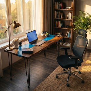 A well-lit home office with a wooden desk, a laptop, a bookshelf filled with books, and a comfortable black office chair.