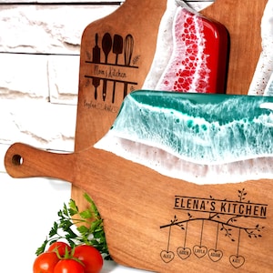 a wooden cutting board with a knife and some tomatoes