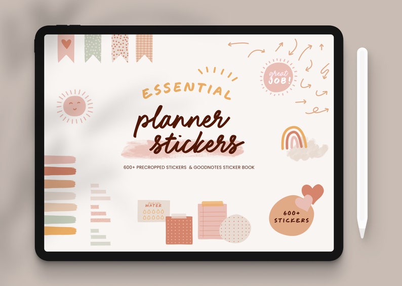 May include: A digital tablet displaying a collection of planner stickers in a variety of colours and designs. The stickers include a sun, a rainbow, hearts, and a water bottle. The text "ESSENTIAL planner stickers" is displayed on the screen. The text "600+ PRECROPPED STICKERS & GOODNOTES STICKER BOOK" is also displayed on the screen.