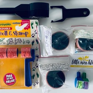 May include: Crayola Washable Roll & Stamp set with three different animal-shaped rollers. The set includes a blue handle and a free roller. The packaging also shows a variety of animal footprints.