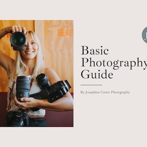 May include: A woman holding multiple cameras in front of a wooden wall. The text "Basic Photography Guide" is displayed on the right side of the image. The text "By Josephine Carter Photography" is displayed below the title.