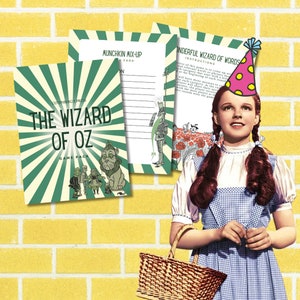May include: A "Wizard of Oz" game pack with a green and cream design, featuring the text "The Wizard of Oz" and illustrations of characters. The image also includes a photo of Dorothy with a party hat and a basket.